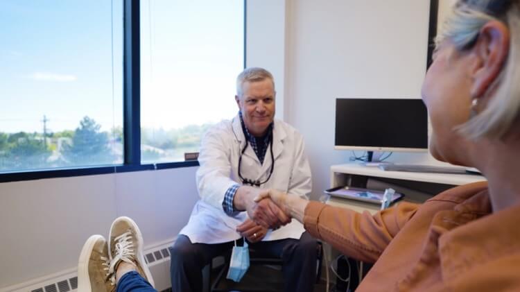Doctor Daren Carlile, a dentist in Columbine, CO, shaking hands with a patient